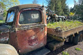 Kirby Neumann-Rea/News-Register##The wheels of an old pickup and “passenger” motorcycle appear permanently embedded in soil on Stoller Drive just off Highway 99W between Lafayette and Dundee.